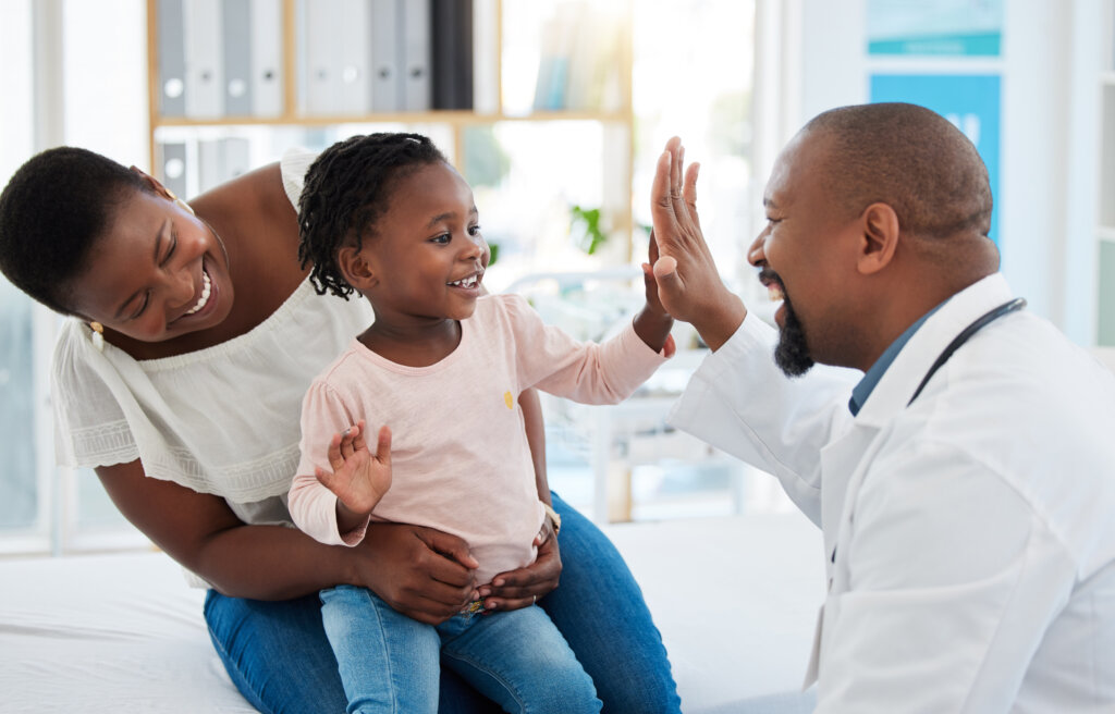 Health Literacy, a child with their mother celebrates a positive doctor's visit