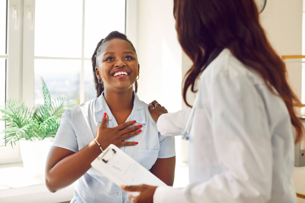 Happy female patient thanking her doctor. Inclusive healthcare.