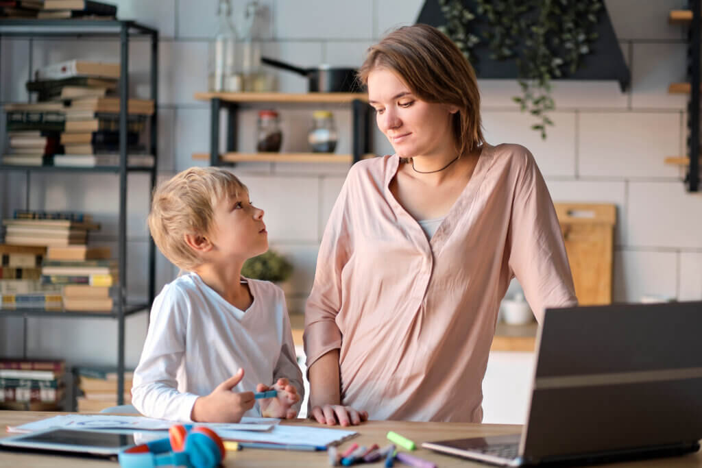 Gen Z healthcare marketing to Young mother with toddler child working on the computer from home