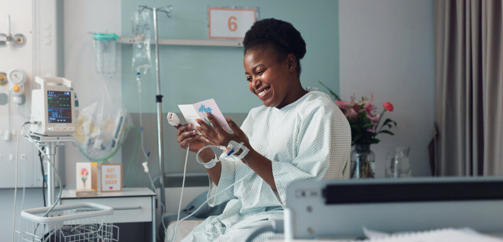 Black Woman, reading Point of Care brochure, POC material in hospital for patient education