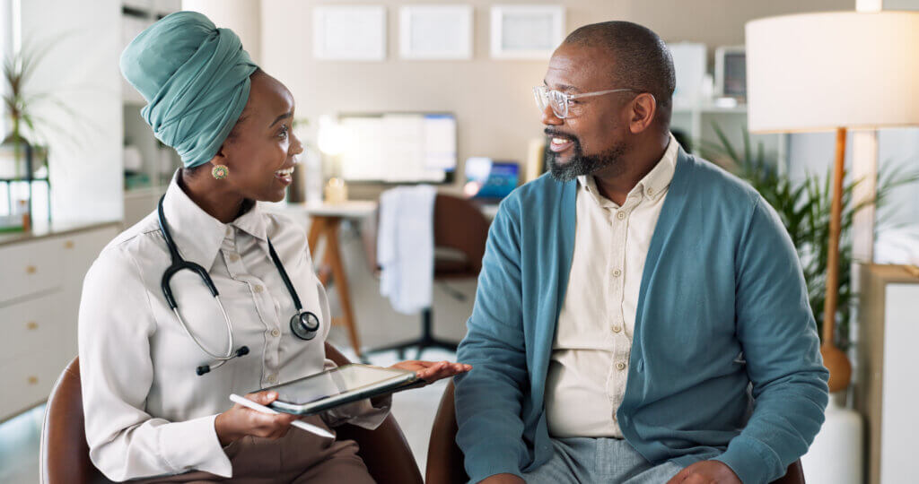 African patient, tablet and talking to happy doctor for healthcare, insurance or excellent exam results. People, technology and medical worker in consultation for wellness, checkup and help in clinic at point of care