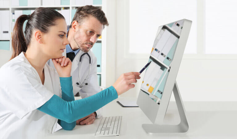 EHR MARKETING Nurse looks at EMR with Doctor