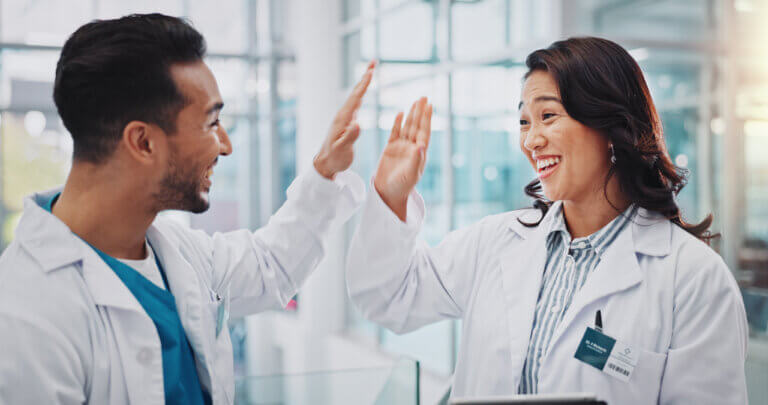 Doctors happy and high five about EHR education